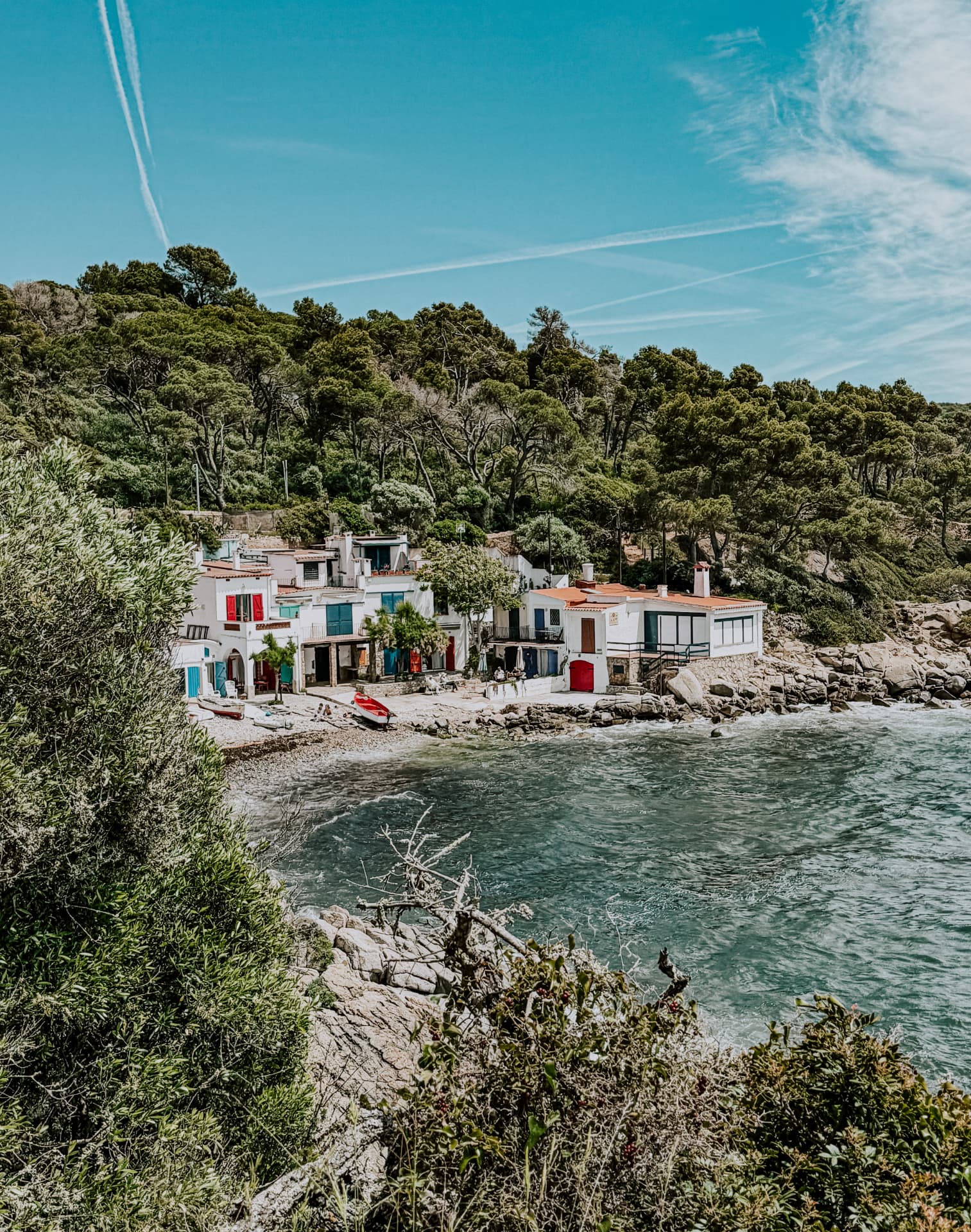 Coastal homes overlooking a clear-water Costa Brava cove